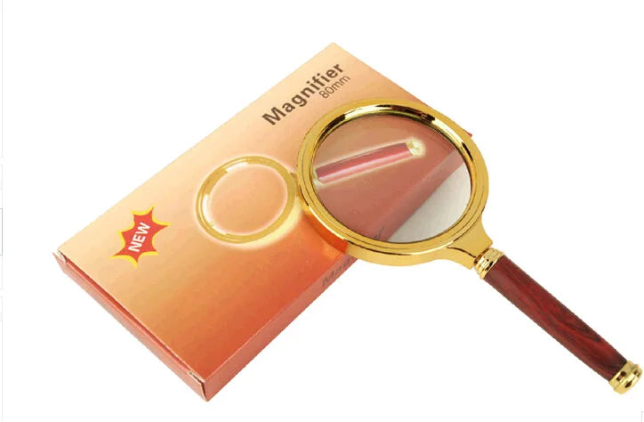 Elegant gold handle magnifying glass for reading newspapers