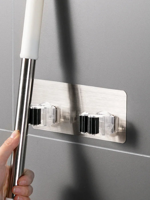 Heavy-duty adhesive wall-mounted mop and broom holders for bathroom storage and organization