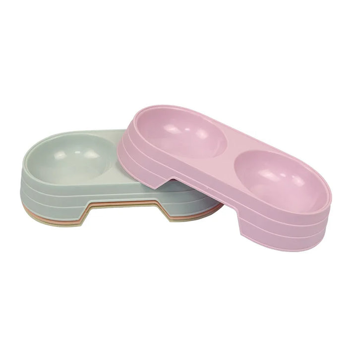 Round plastic pet food bowl with two bowls