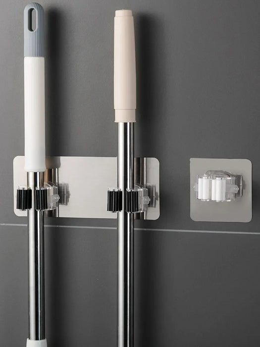 Heavy-duty adhesive wall-mounted mop and broom holders for bathroom storage and organization