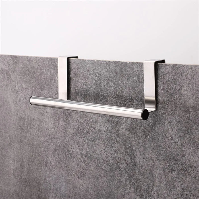 Stainless steel towel bar hanging behind cabinet door with rubber pad