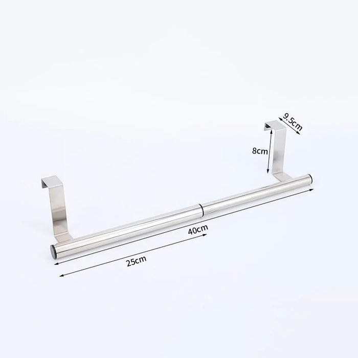 Stainless steel towel bar hanging behind cabinet door with rubber pad