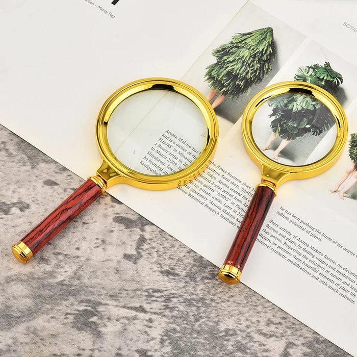 Elegant gold handle magnifying glass for reading newspapers